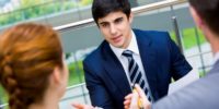 Portrait of confident businessman sharing his ideas with associates at meeting
